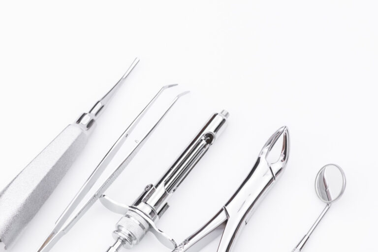 a close up of a set of surgical tools on a white surface