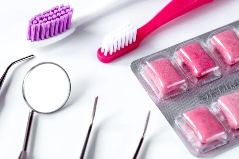 a close up of a pink toothbrush, a pink toothbrush, and a pink pill pack