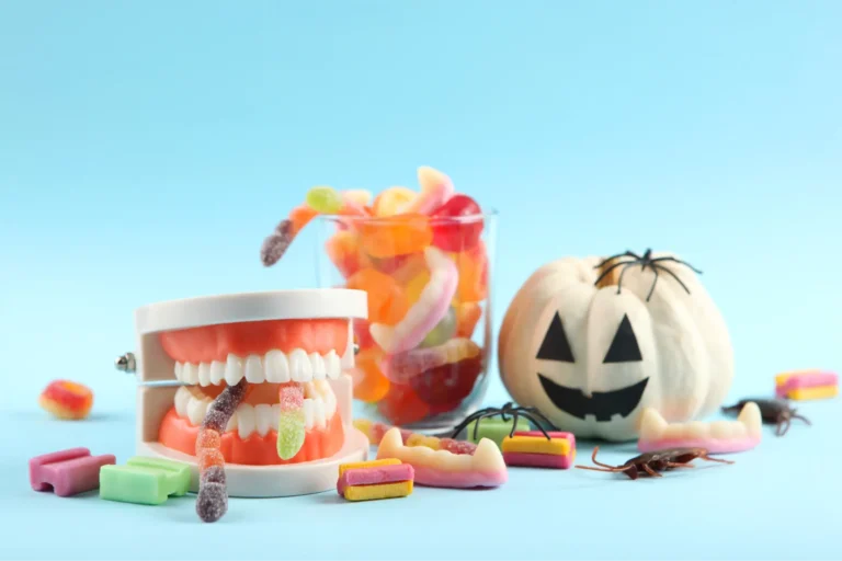 there are candy and candy candies in a jar and a halloween pumpkin