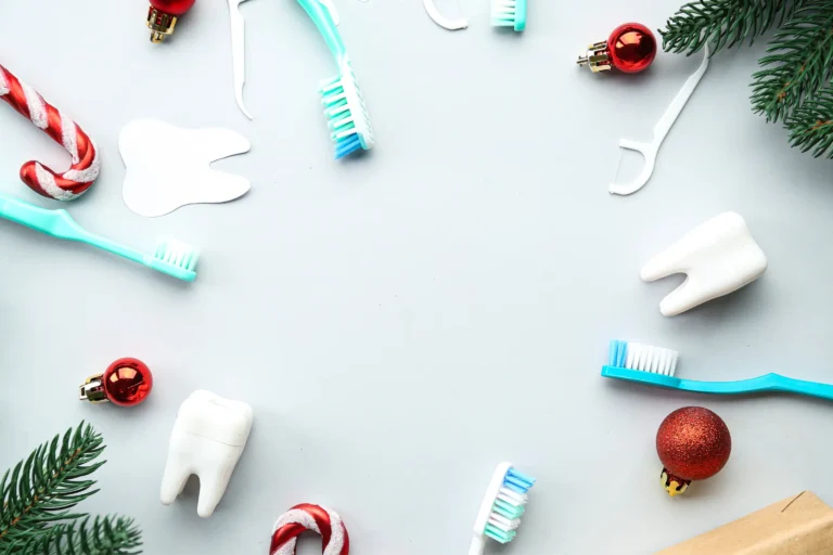 a close up of a toothbrush, toothpaste, christmas ornaments, and a gift