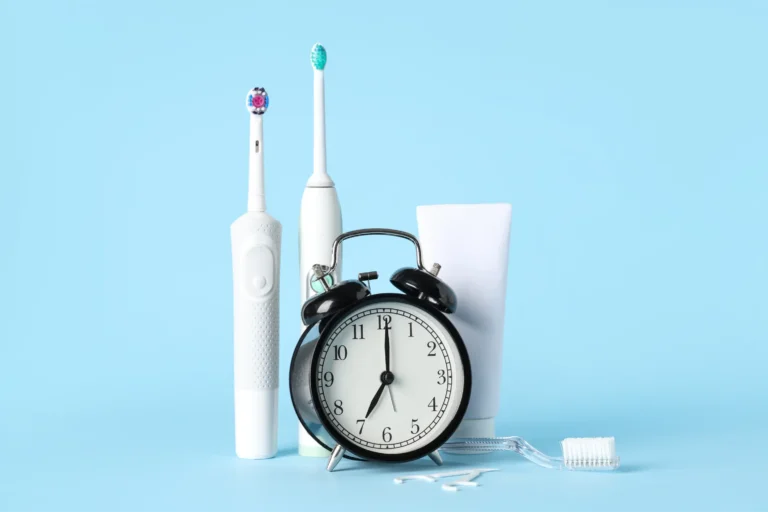 there is a clock and a toothbrush next to a toothpaste