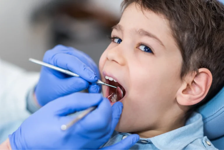 arafed child getting his teeth checked by a dentist