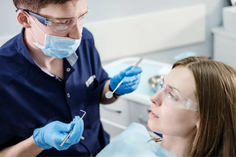 arafed woman getting her teeth examined by a dentist