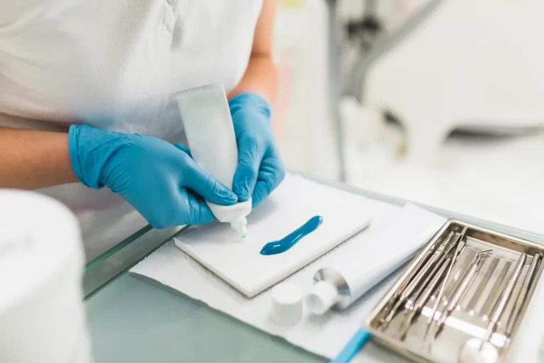 someone is preparing to use a toothbrush in a dental office