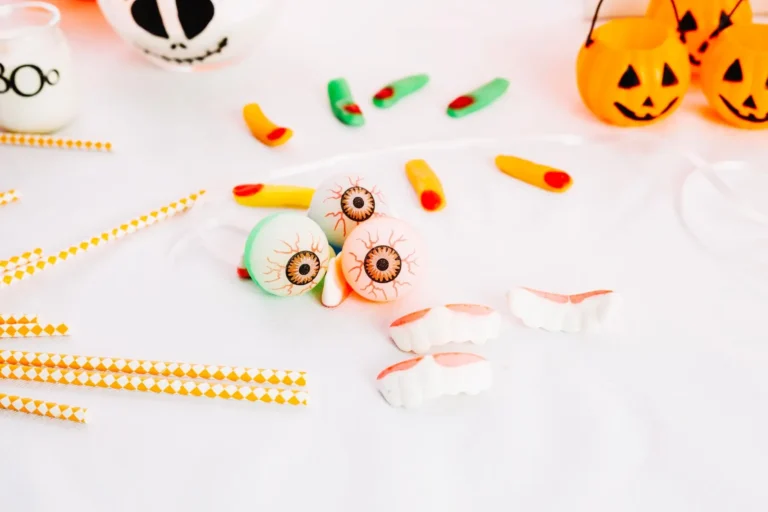 there are many halloween decorations on the table with orange and white straws