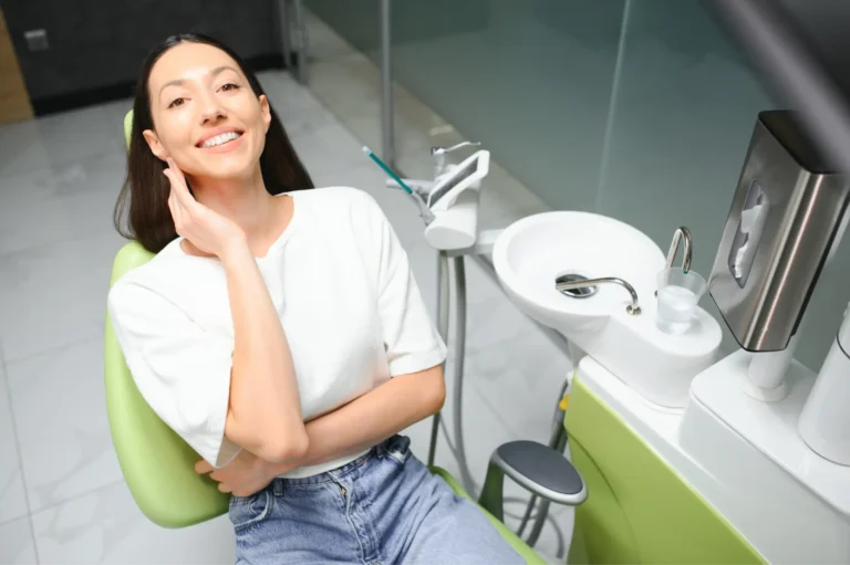 woman sitting in a chair in a dental office with a toothbrush