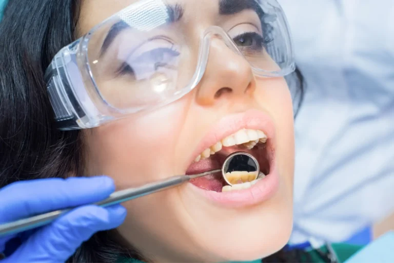 arafed woman with goggles and goggles is getting her teeth brushed