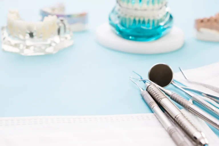 there are dental tools on a table with a blue background