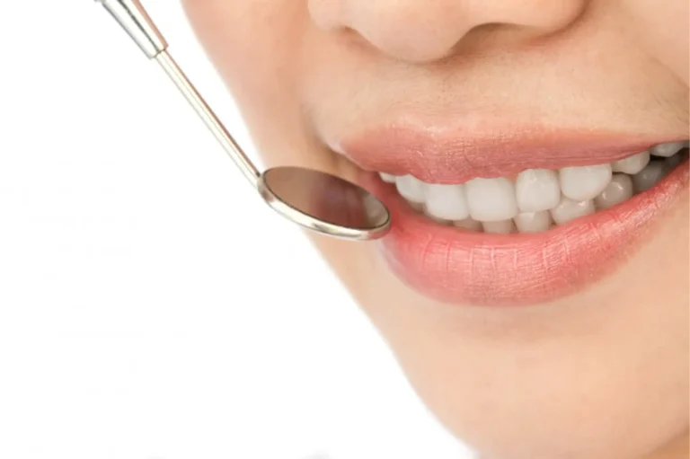 smiling woman with a spoon in her mouth and a toothbrush in her mouth