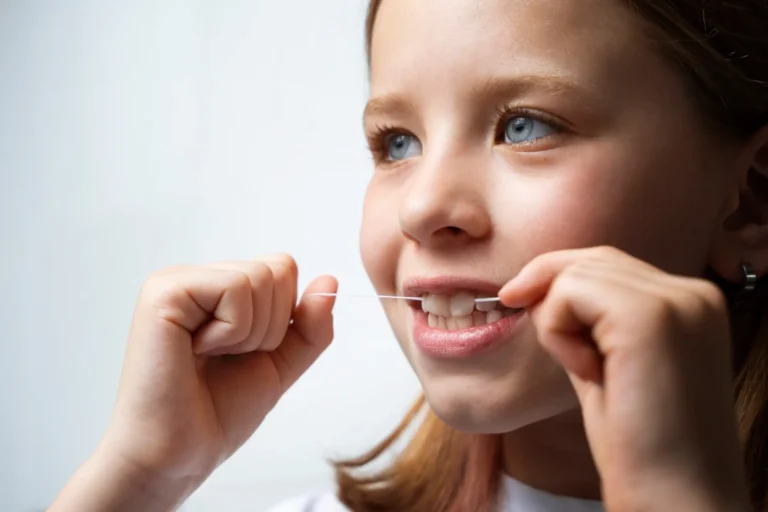 there is a young girl brushing her teeth with a toothbrush