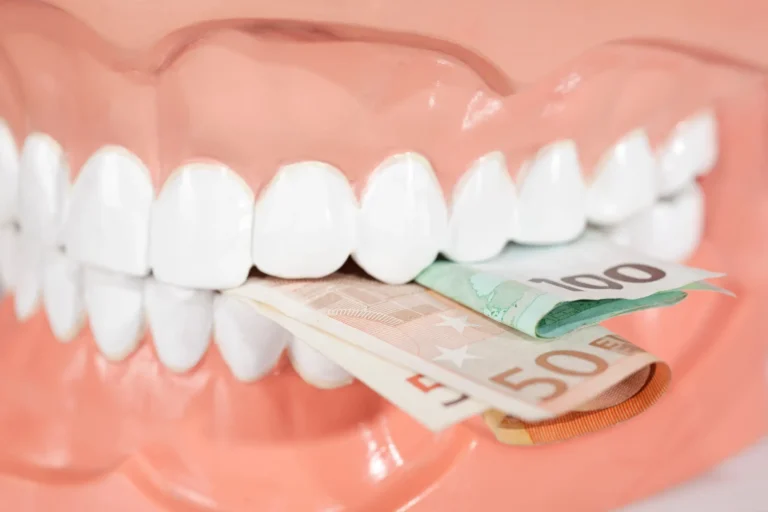 a close up of a tooth with a toothbrush and money in it