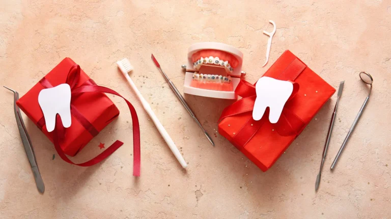 there are two toothbrushes, a toothpaste, a gift box, and a pair