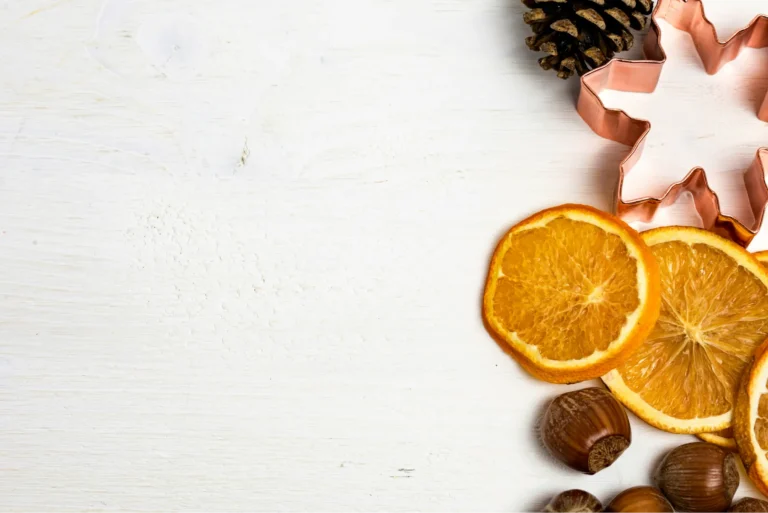 there are oranges, nuts, and other fruits on a white table