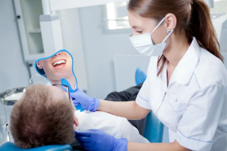 arafed male patient in a dental office getting his teeth brushed