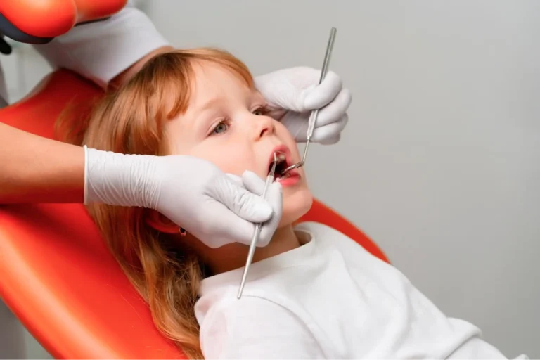 arafed child getting her teeth examined by a dentist