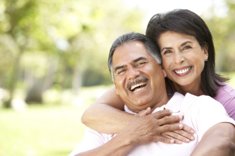 smiling couple embracing each other in a park