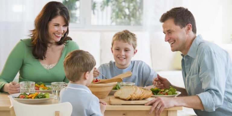 there are a group of people sitting at a table eating