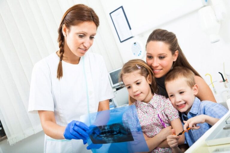 arafed woman and two children looking at a picture of a dentist