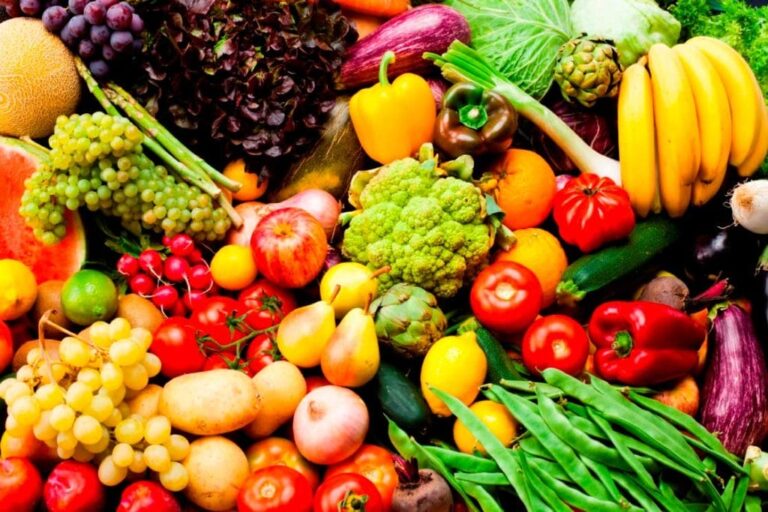 a close up of a pile of different fruits and vegetables