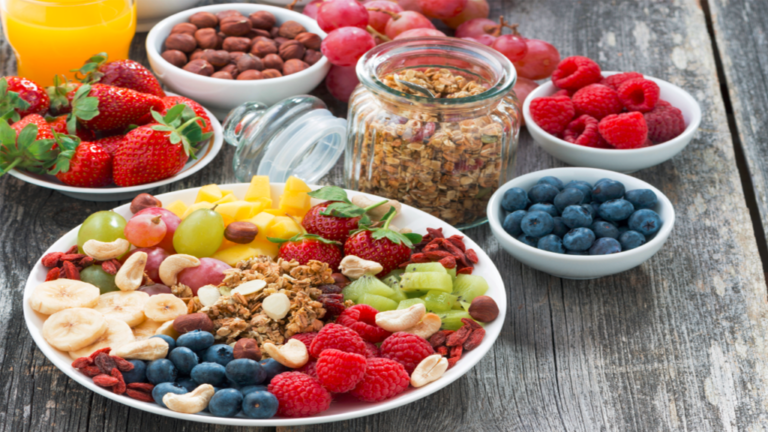 there are many different fruits and nuts on a plate on a table