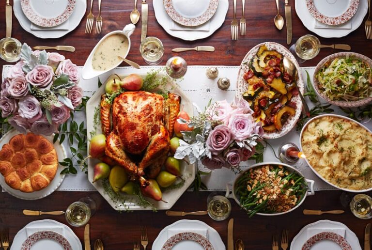 a close up of a table with a turkey and other food