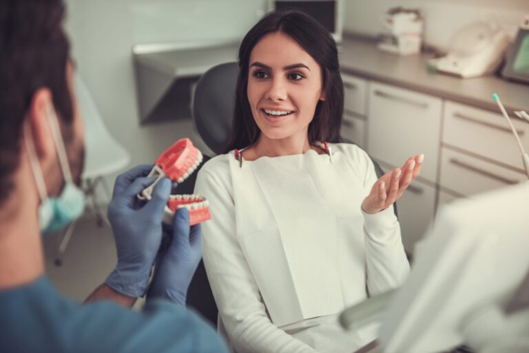 arafed woman sitting in a dentist chair with a toothbrush in her hand