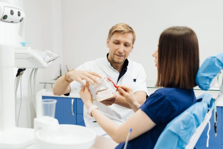 there is a man and woman sitting in a dentist ' s chair