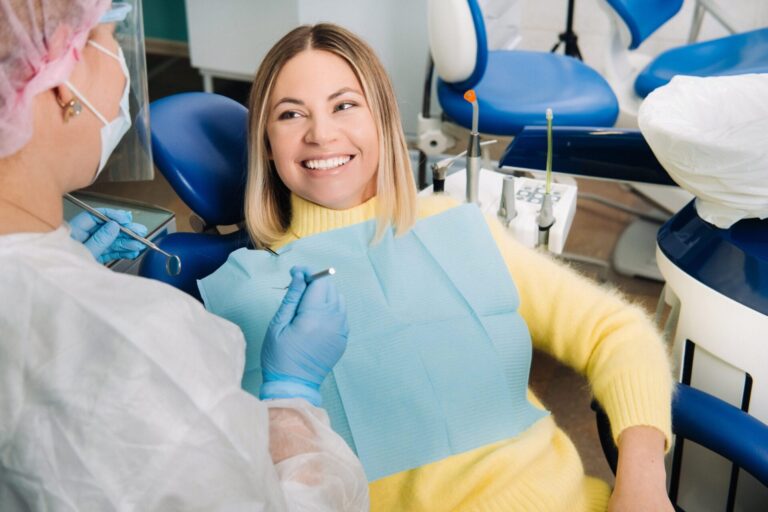 woman sitting in a chair with a toothbrush in her mouth