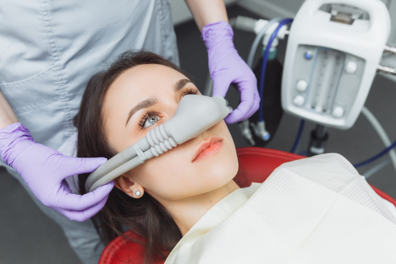 arafed woman getting her teeth examined by a dentist