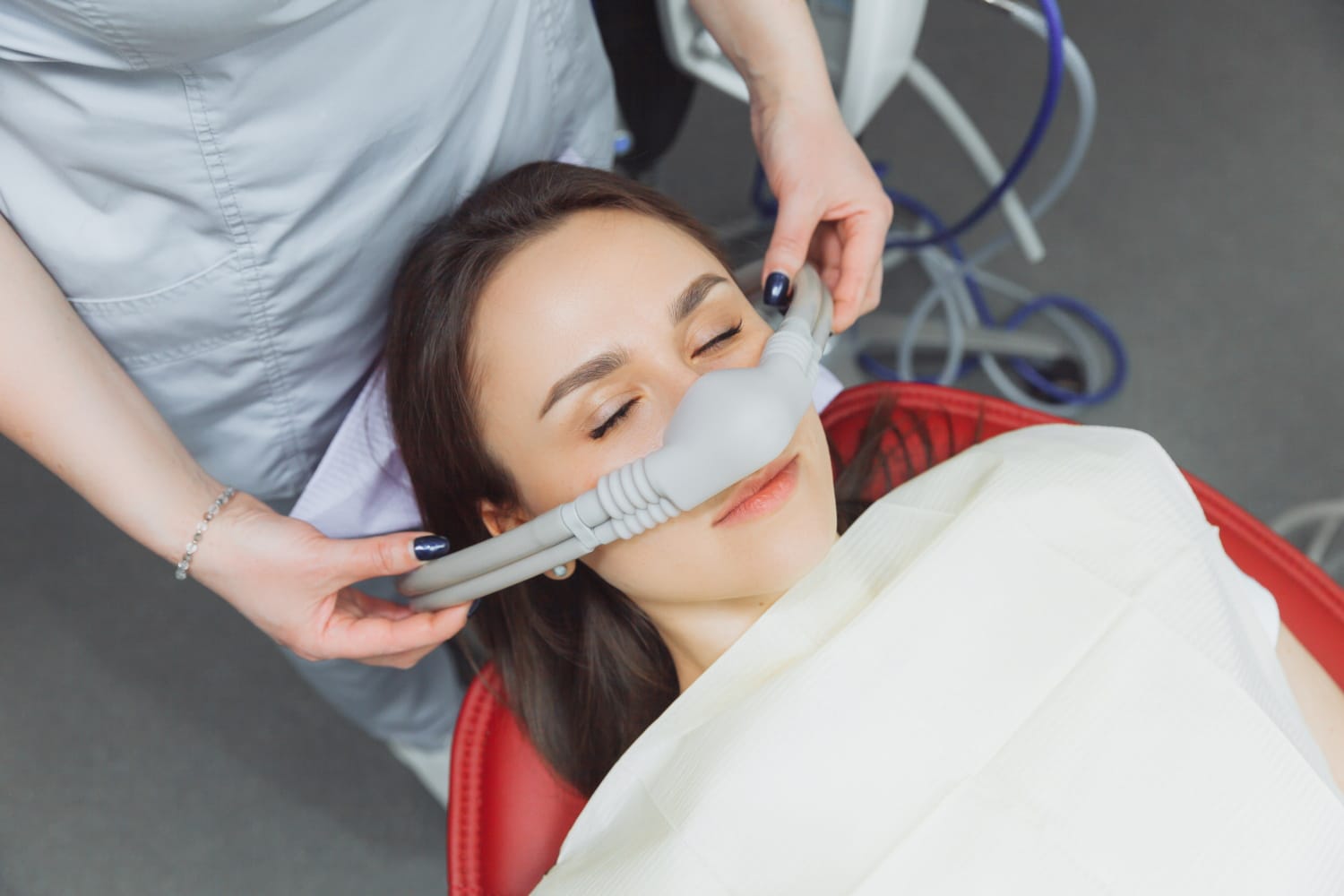 dentist puts inhalation sedative mask his patient