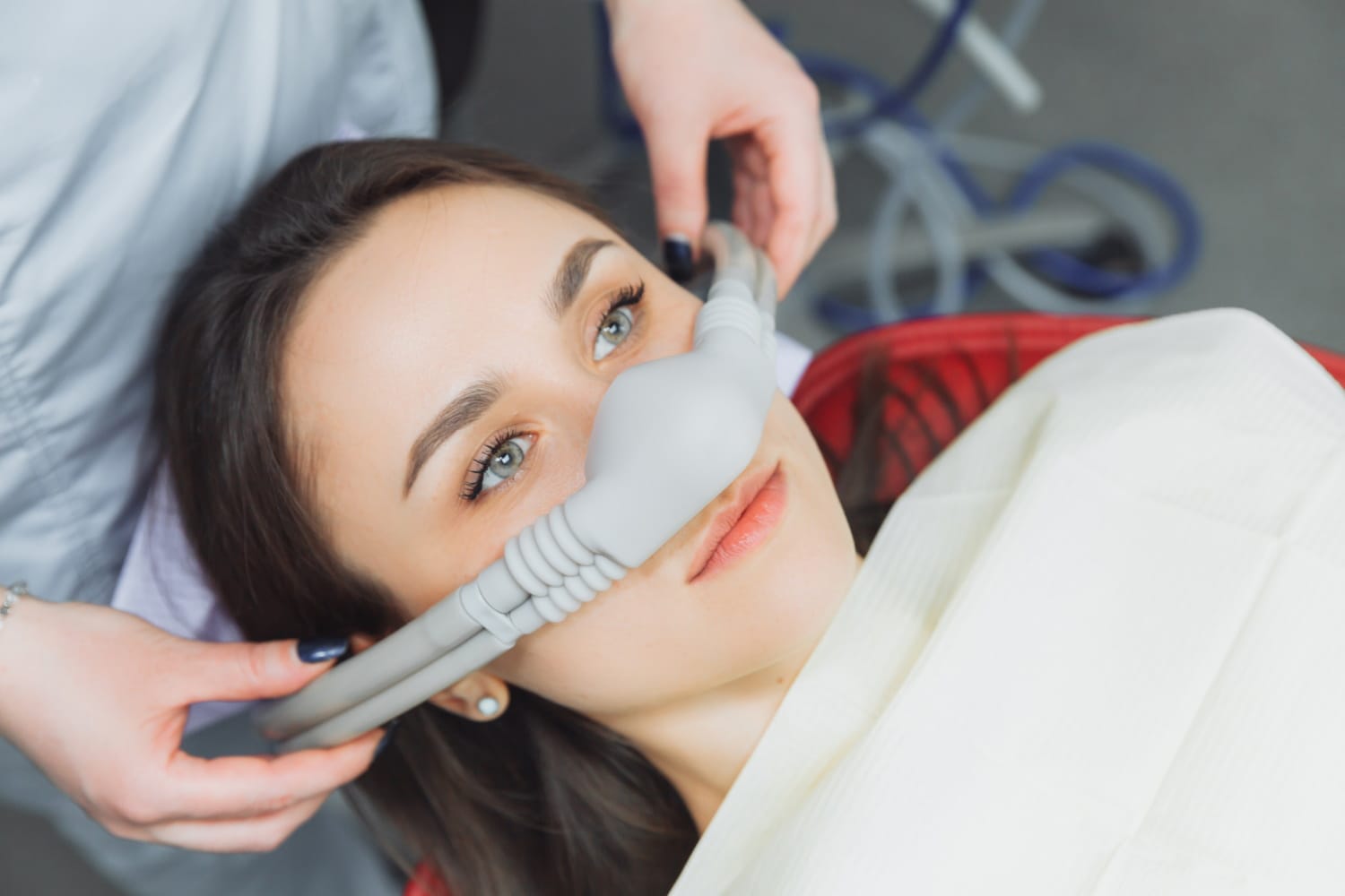 dentist puts inhalation sedative mask his patient