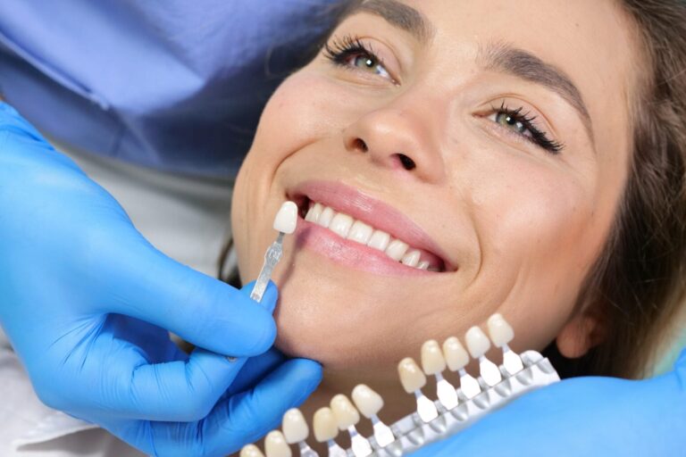 smiling woman getting teeth examined by dentist in dental office