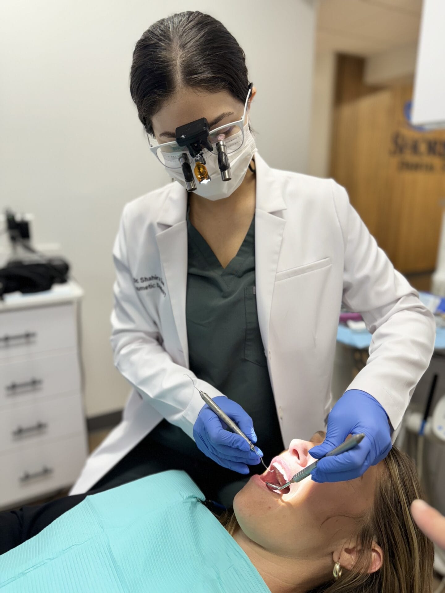 arafed woman getting her teeth examined by a dentist