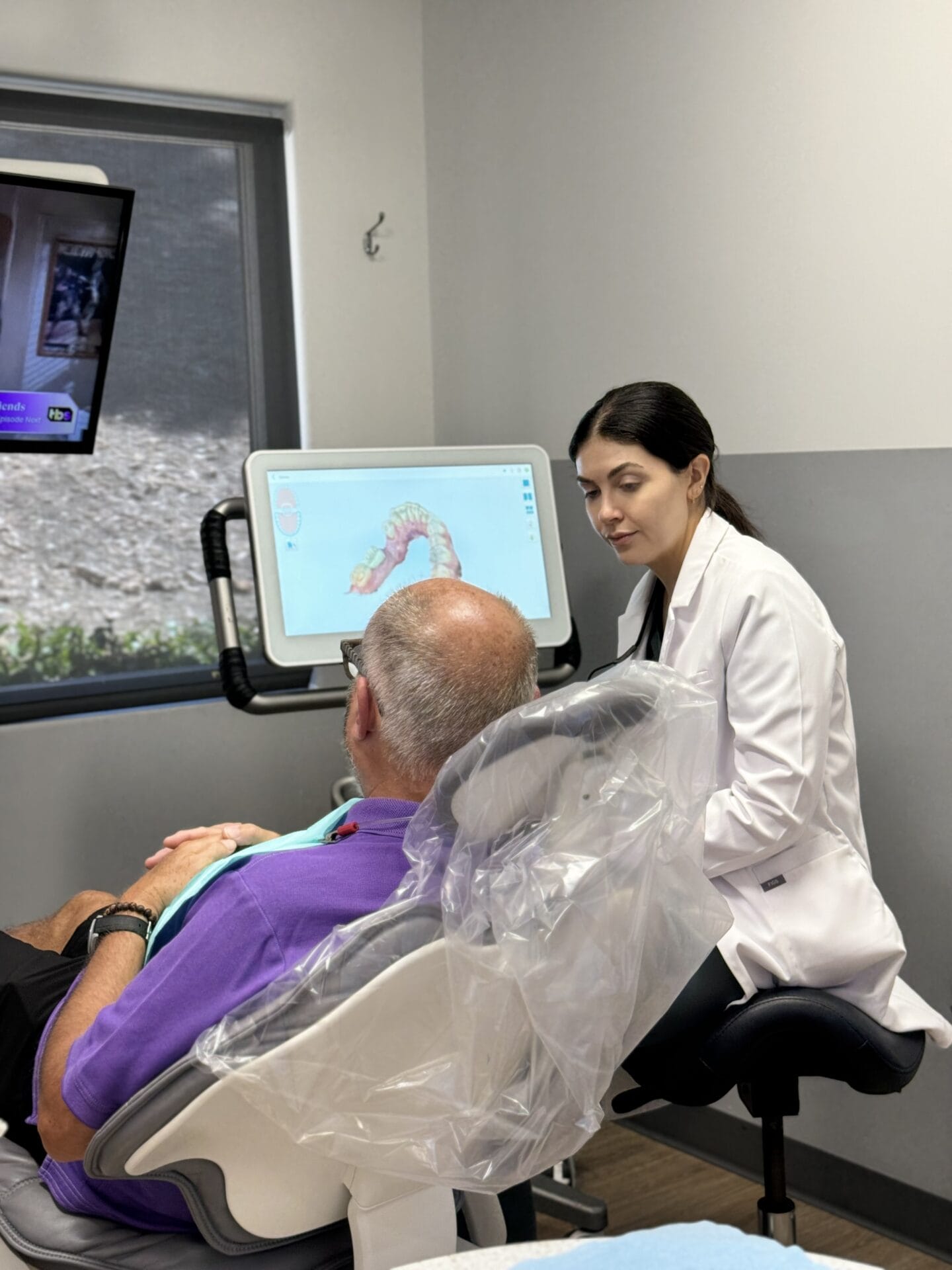 woman in a chair with a man in a chair in front of a tv