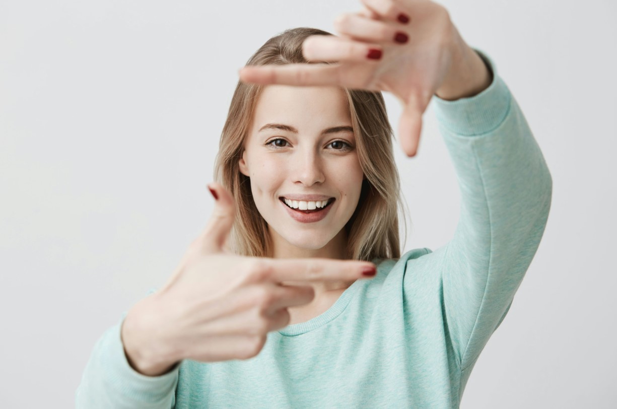 there is a woman making a gesture with her hands