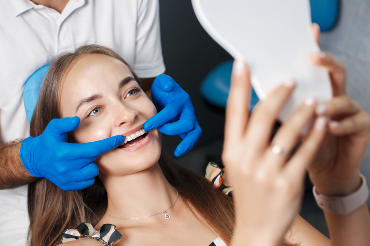 arafed woman getting her teeth examined by a dentist