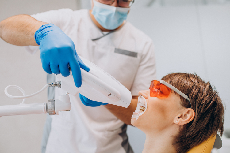 arafed woman getting her teeth examined by a dentist