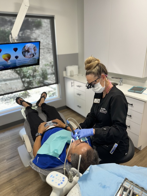 arafed man in a dental chair being examined by a dentist