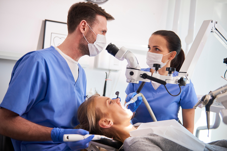 arafed woman in a dentist chair with a man in a mask