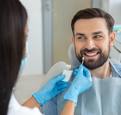 arafed man in a dental chair getting his teeth brushed by a dentist