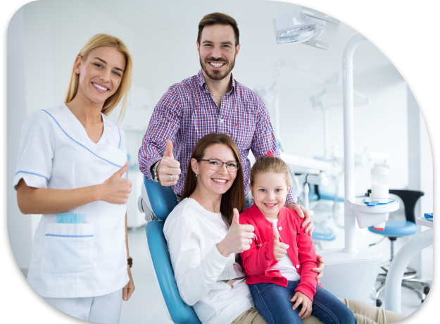 arafed family sitting in a dental chair with thumbs up