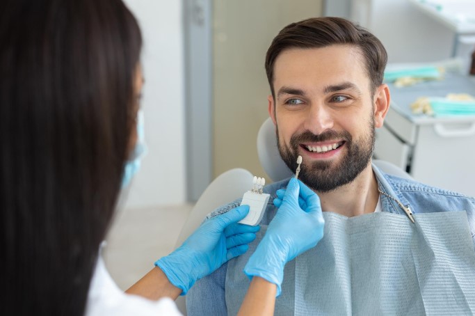 arafed man getting his teeth examined by a dentist