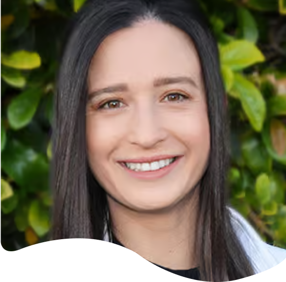 smiling woman with long black hair and a white shirt