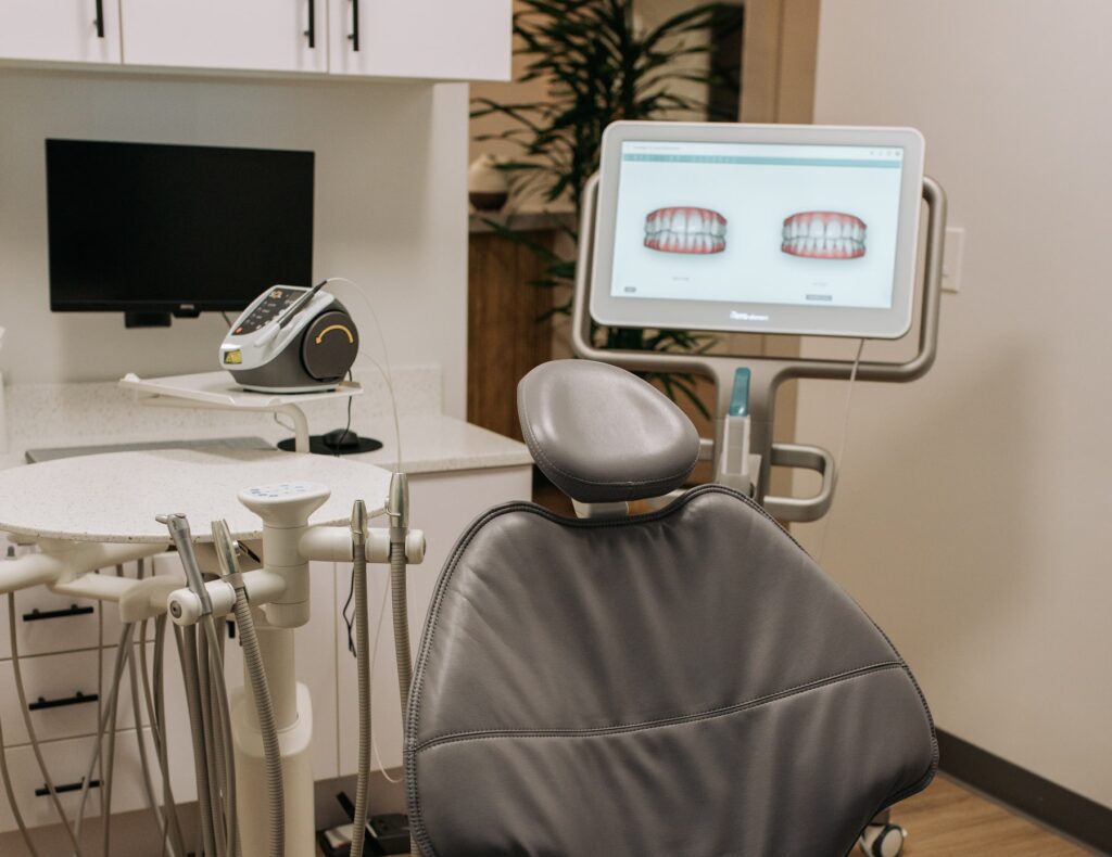 there is a dentist chair in the corner of a room