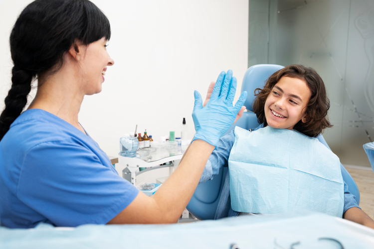 woman in blue shirt sitting in chair with blue glove on