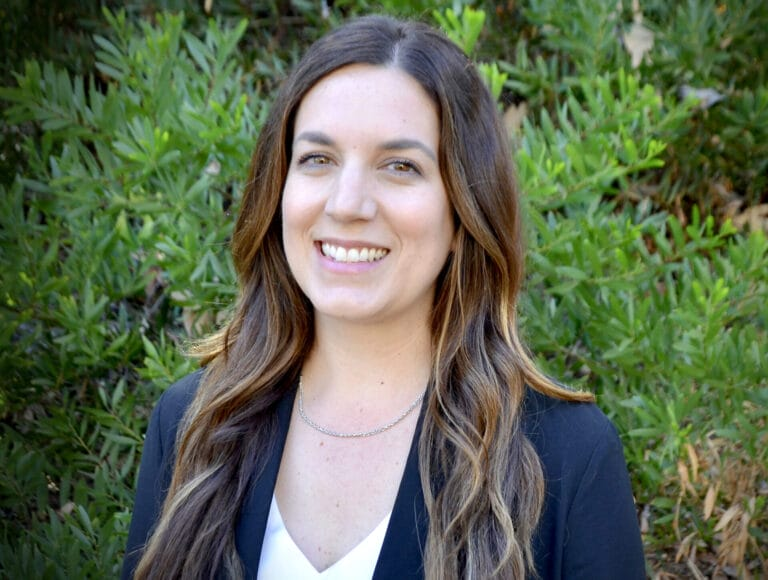 a close up of a woman with long hair and a black jacket