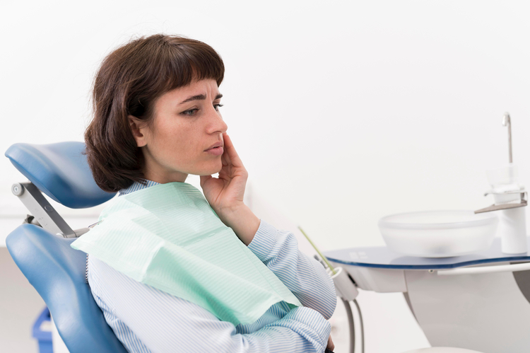 woman sitting in a chair with a toothbrush in her hand