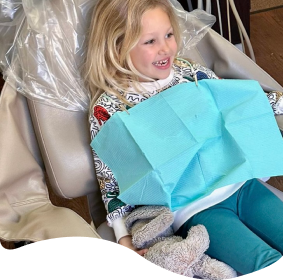 arafed child sitting in a chair with a blue bag on her lap