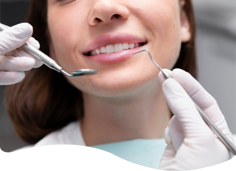 woman with a toothbrush and a dental instrument in her hand