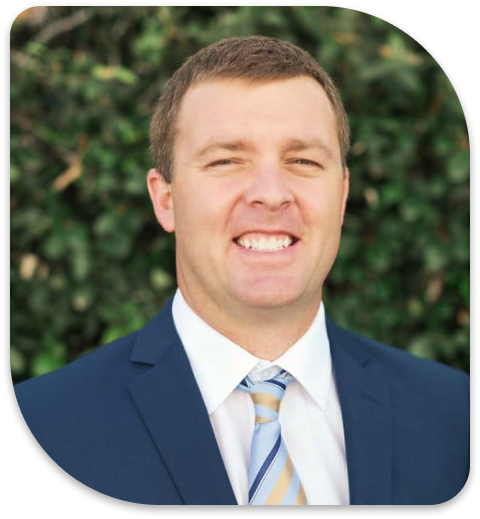 a close up of a man in a suit and tie smiling